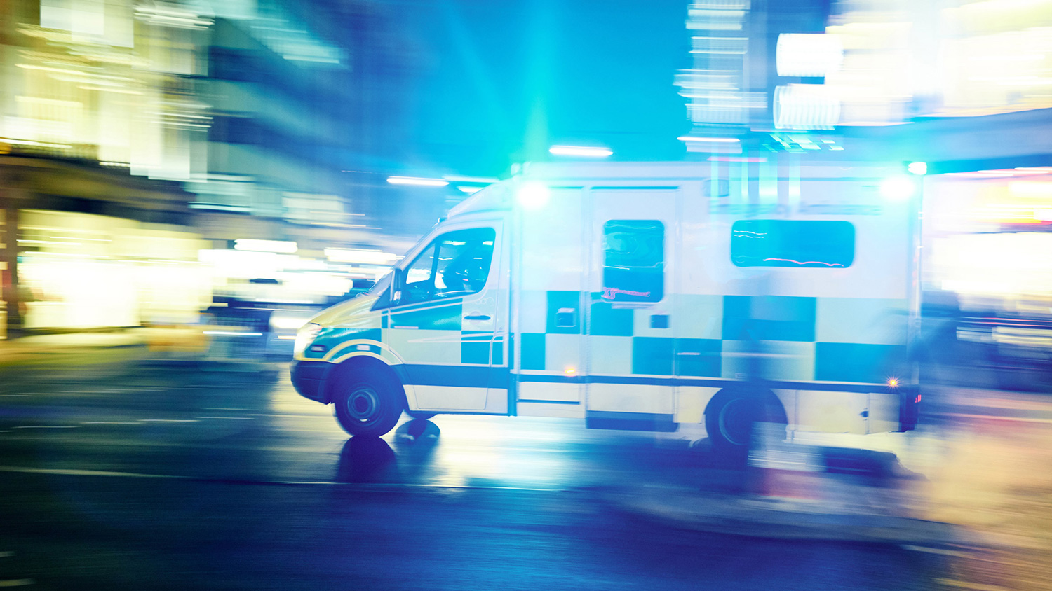 An ambulance speeds to hospital