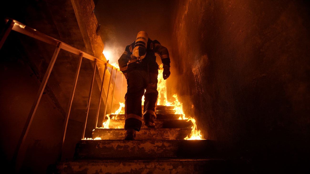 A firefighter in a burning building