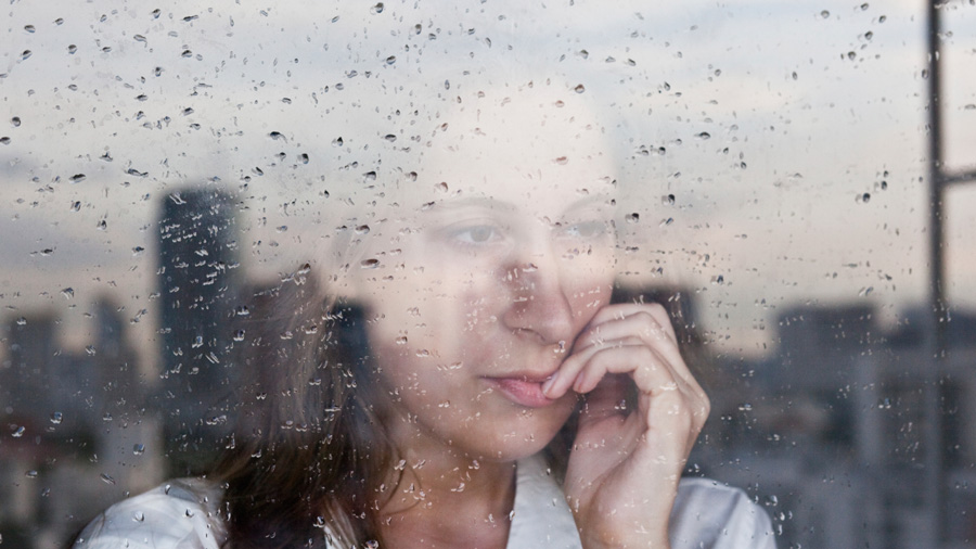 An anxious-looking woman at a window