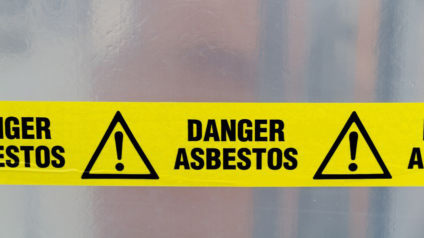 A hazard sign warns of asbestos