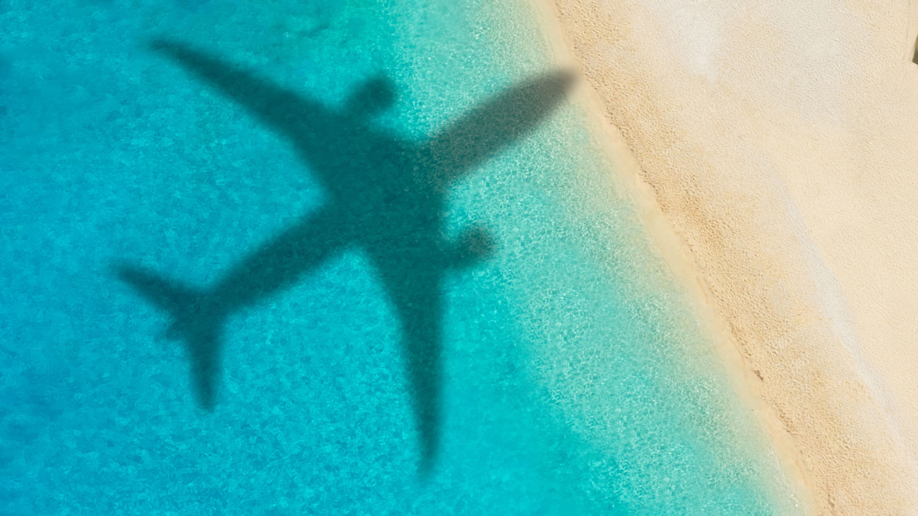 An airplane flying over a beach