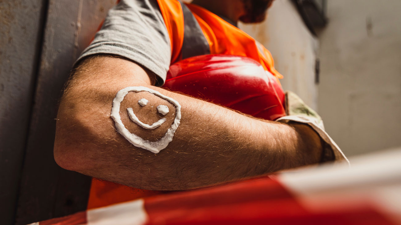 Construction worker with sun cream on arm
