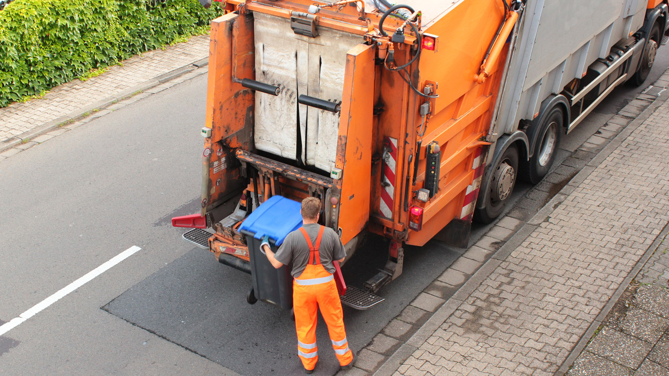 A refuse worker collecting rubbish