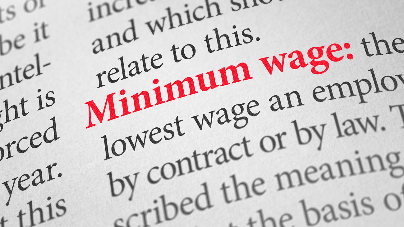 The term minimum wage highlighted in a dictionary