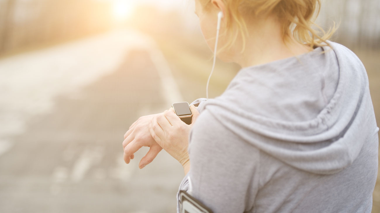 A runner uses a wearable fitness device